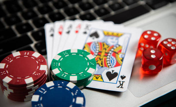 Poker chips and cards on computer keyboard